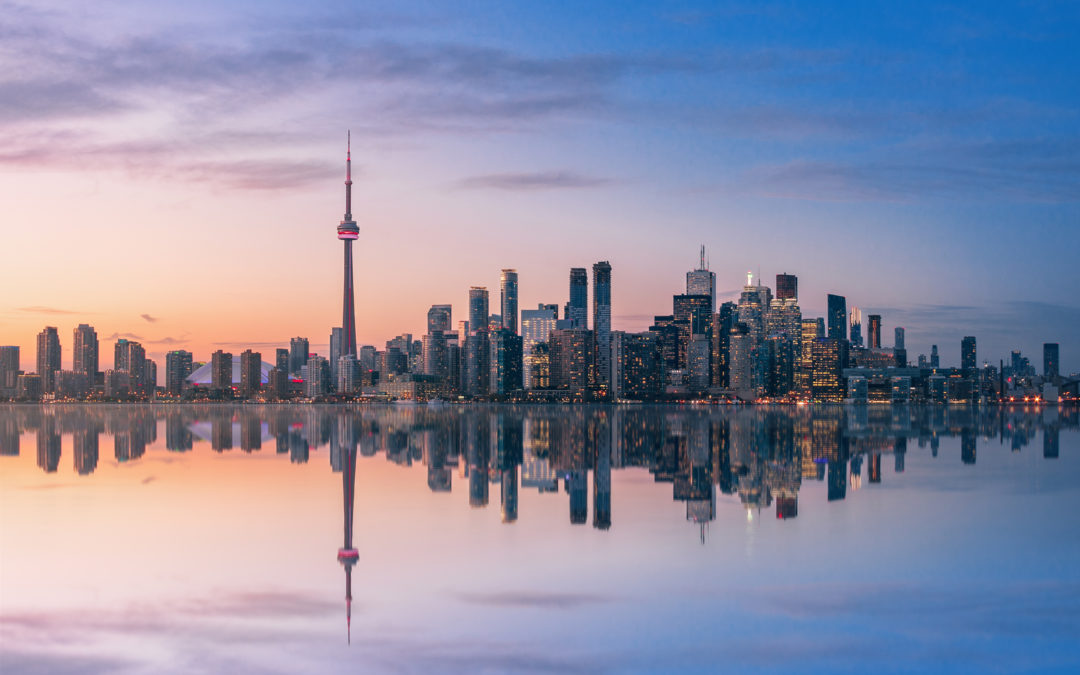 Toronto skyline with CN Tower and lake reflection at dusk