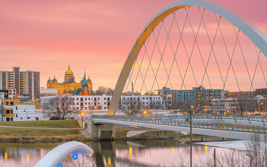 Des Moines skyline at sunset with the Iowa Women of Achievement Bridge.