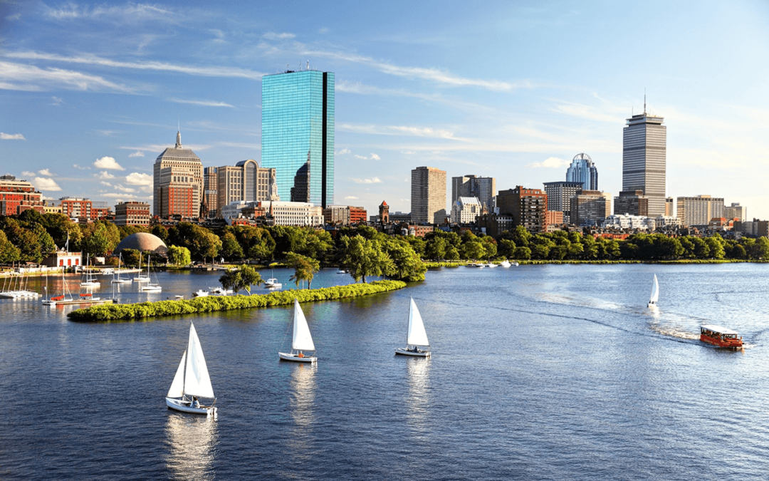 Sailboats on the Charles River with Boston skyline in the background.