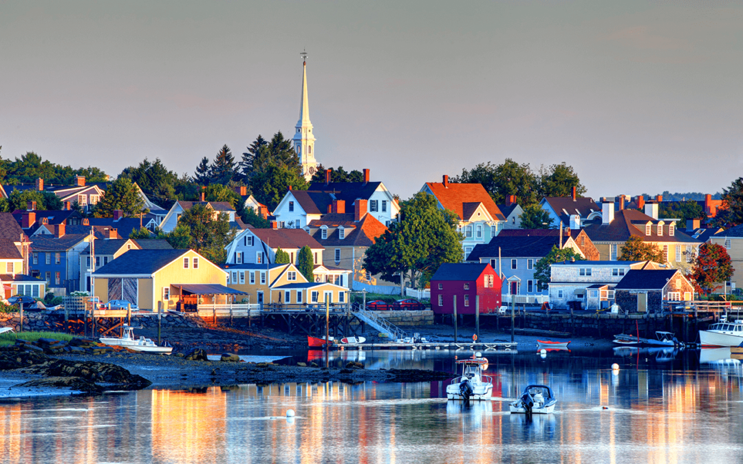 Scenic coastal town with colorful houses and boats in New Hampshire.