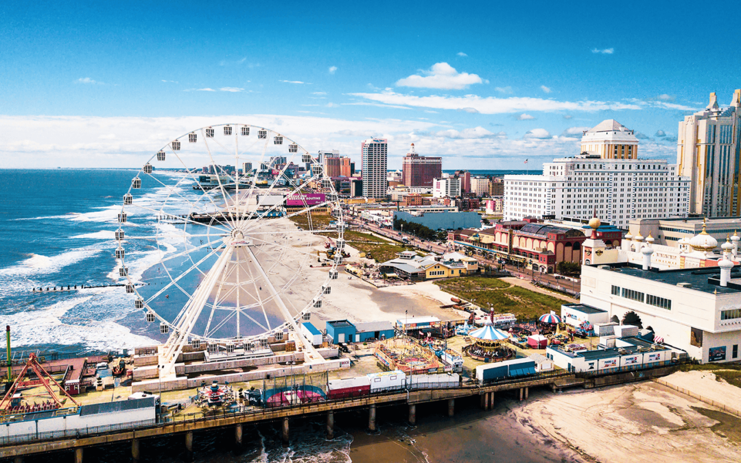 Ferris wheel on the Atlantic City boardwalk in New Jersey with a view of the ocean.