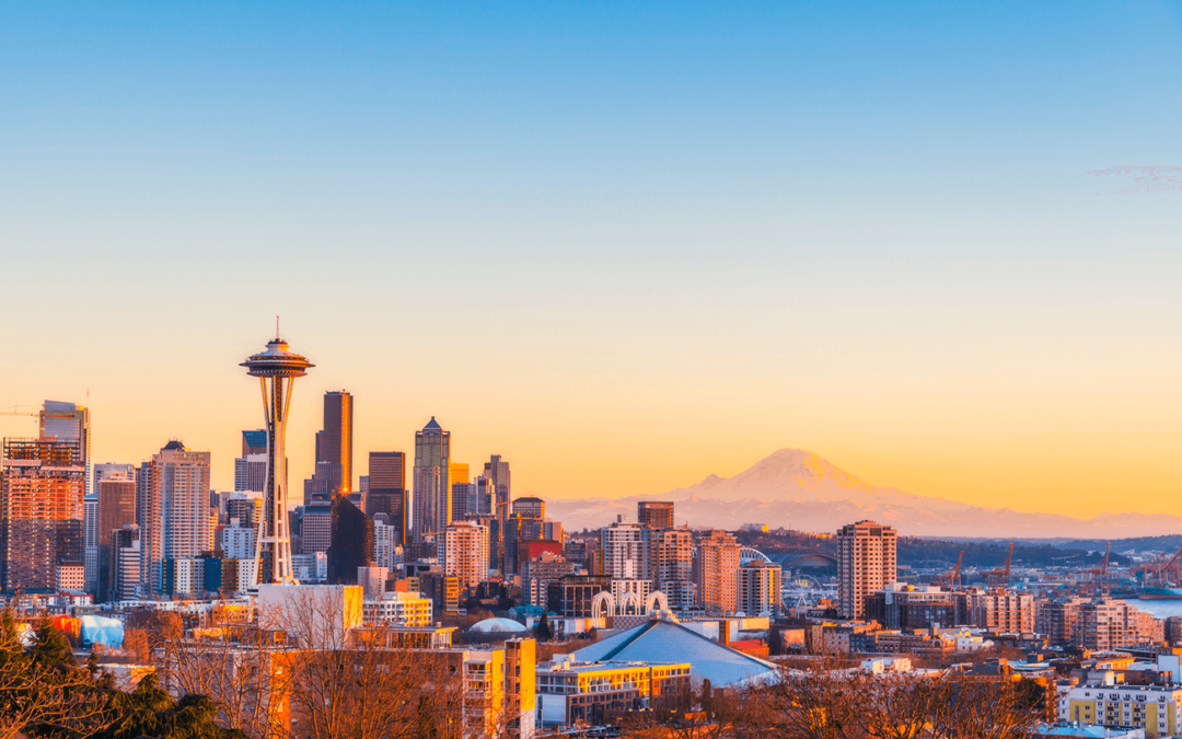 Seattle skyline with Space Needle and Mount Rainier at sunrise.