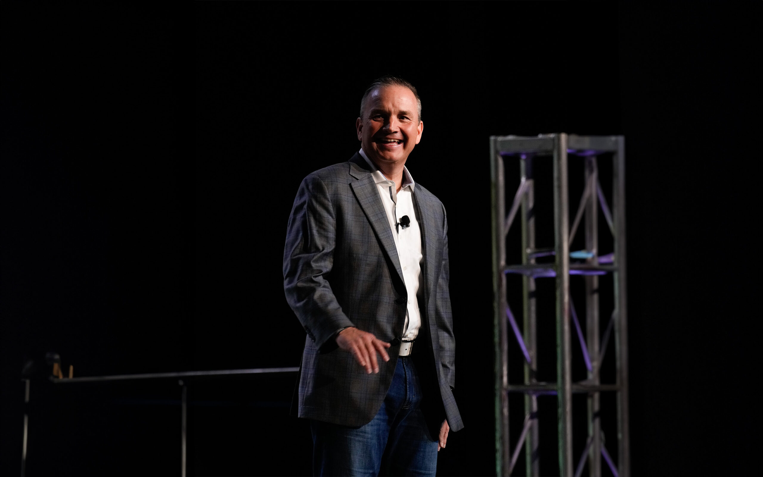 Chris Stuart speaking on stage during a presentation.