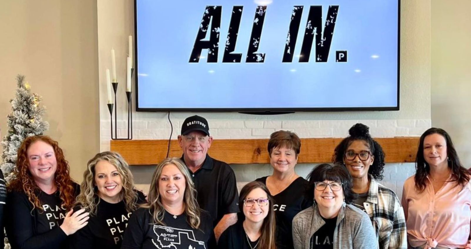 A PLACE team gathers for a strategy session, emphasizing collaboration and commitment to a successful real estate business plan.